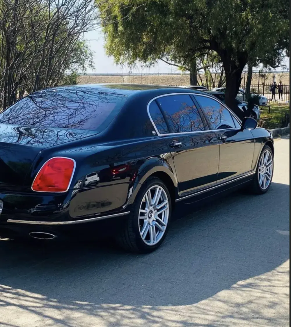 A black Bentley parked outside the school
