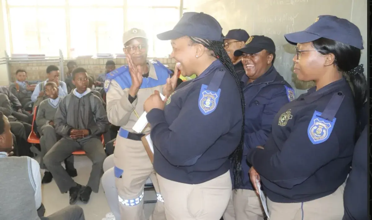 Police and traffic officers speaking with Lephola learners in a classroom